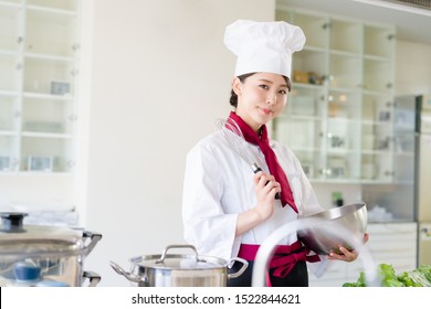 Asian Female Chef In Kitchen. Cooking. Restaurant.