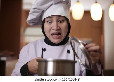 Asian Female Chef Open Cooking Pot And Smelling Food Aroma That She Cooked, Failure In Cooking Concept, Bad Worried Face Expression