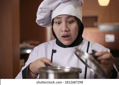 Asian Female Chef Open Cooking Pot And Smelling Food Aroma That She Cooked, Failure In Cooking Concept, Bad Worried Face Expression