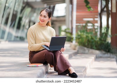 Asian Female College Student Sitting On The Floor With A Tablet
And Study With Tablet In College Or Private School Technology Teaching Concept