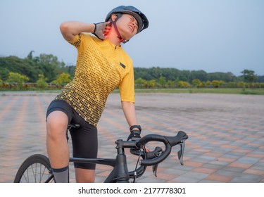Asian female cyclist having neck pain from riding a bike long time. Poor posture is a major contributor to neck pain whilst cycling. - Shutterstock ID 2177778301