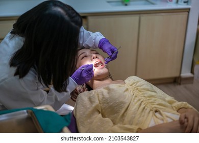 Asian Female Dentist Check Up Her Patient Teeth Healthy In Dental's Office. Dental Care, Medical Care, Lifestyle, Dental Clinic Or Dental Procedure Concepts