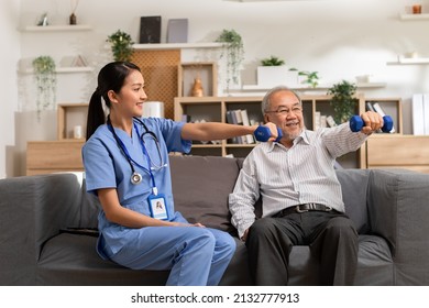 Asian female doctor advice elderly patient to physiotherapist to exercise with dumbbell at home.Smiling nurse helping senior patient workout exercise to build muscle strong.Physiotherapist Nursing. - Shutterstock ID 2132777913