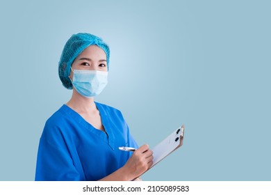 Asian Female Doctor In Blue Surgical Gown, Isolated Background