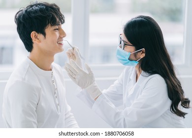 Asian female doctor checking a patient's teeth
 - Powered by Shutterstock