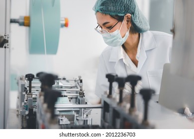 Asian Female Doctor Or Engineer Working At Clean Medical Mask Production Factory, Production Hygiene Medical Mask Manufacturing Qaulity Inspection Concept