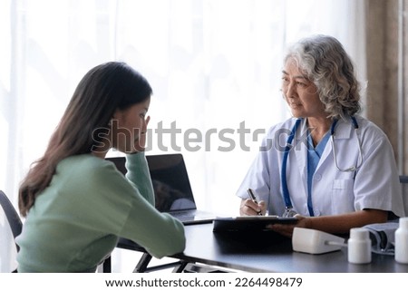 Asian female doctor examining a patient to assess the illness for proper treatment.