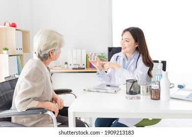 asian female doctor explaining about how to use medicine with old patient in hospital, elderly disease treatment, she holding drug strip pack with hand