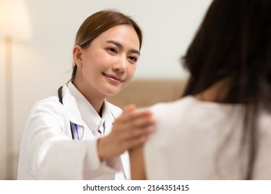 Asian Female Doctor Giving Hope And Encourage To Stressed Woman Patient At Hospital. Smiling Doctor Woman Touching On Patient Shoulder To Support Take Care And Helping . Supported And Encouraged