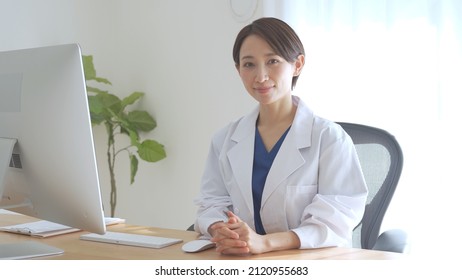 Asian Female Doctor Laughing With A Smile