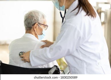 Asian Female Doctor Listening To Sounds From The Heart And Lungs Of Senior Woman At The Back Of The Body With A Stethoscope,health Examination Of Elderly Patient,medical Diagnosis,check Up Concept