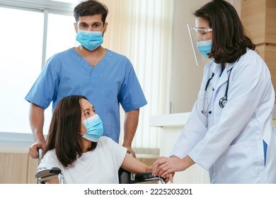 Asian Female Doctor With Male Nurse Wearing Protective Face Mask Reassured And Consult Young Woman Patient Before Surgery Treatment At Hospital.