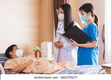 Asian Female Doctor And Nurse Wearing Mask Checking Health Of Senior Old Patient In Hospital Recovery Room. Woman Medic Checking Heart Rate Pulse And Giving Health Care Advisory.