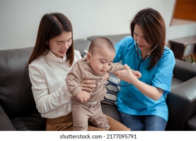 Asian Female Doctor Pediatrician Holding Stethoscope Checkup Child Newborn Baby Boy Patient Visit Doctor With Mother At Home, Mom Protection Children Medical Care Concept.