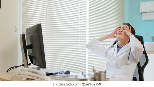 Asian Female Doctor Physician Has Stress Headache Because Of Overworked In Hospital And She Feel Depress