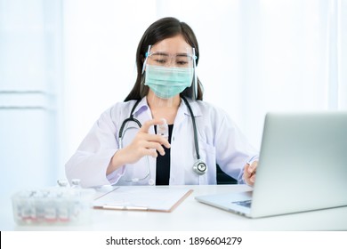 Asian Female Doctor Reporting A Diagnostic Result Of Coronavirus Or COVID-19 Vaccine Usage In Patient, 2019-nCoV COVID19 Cases Statistic. Woman Analyst - Researcher Making A Video Conference.