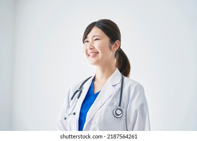 Asian Female Doctor Smiling In White Background