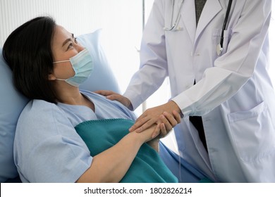 Asian Female Doctor Taking Care Of Asian Female Patient In Hospital Room