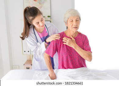 Asian Female Doctor Talk About Disease Symptoms With Old Stroke Patient In Hospital, Doctor Use Hand Touch On Shoulder Of Patient And Asses To Treatment, Rehabilitation Process, Elderly Healthcare