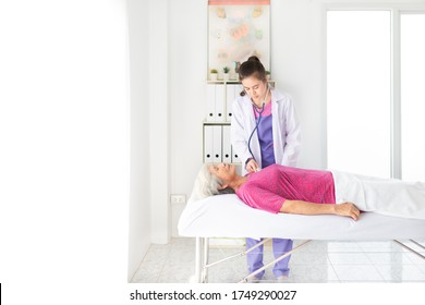 Asian Female Doctor Use Stethoscope Listening And Screening Old Asian Patient, Elderly Health Check Up , Palliative Care, Unconscious Patient Treatment