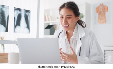 Asian female doctor using laptop computer online video call remote talking to patient, prescribe medicine. Tele medical, telehealth, hospital clinic health care service, or internet technology concept - Shutterstock ID 1912593001