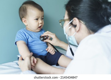 Asian Female Doctor Using Stethoscope For Checking Heart Beat And Lungs With Patient Baby Boy, Medical Exam