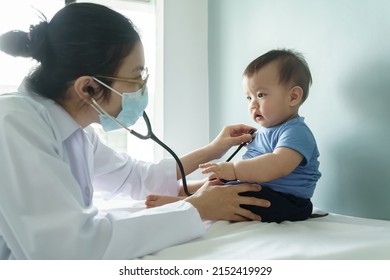 Asian Female Doctor Using Stethoscope Examining Small Baby Boy In Medical Room At Hospital, Healthcare Medical Exam Concept.
