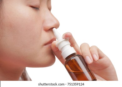 Asian Female Doing Nasal Irrigation By Using Normal Saline Solutiona Spray Isolated With Copy Space To Add Text