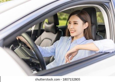 Asian Female Driver  Sit In The Car And Smile 