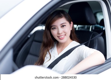 Asian Female Driver Touching Dashboard In Car