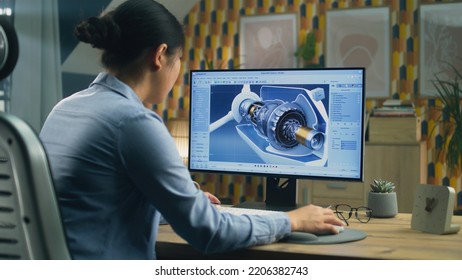 Asian female engineer drawing wind turbine 3D spare part in professional 3D modeling program on pc while working on project at home office