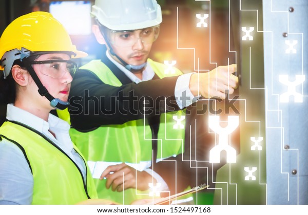Asian female\
engineer factory inspection with man business engineer in industry\
She wears a helmet female working metalwork control in industrial\
In a plastic factory for\
car
