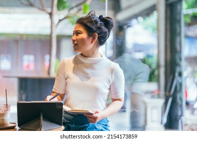 Asian Female Freelance Digital Nomad Career Happiness Workation Cheerful Smiling Working Online With Smart Device Tablet Smartphone Abroad Occupation Project Work Anywhere New Frameless Lifestyle Cafe