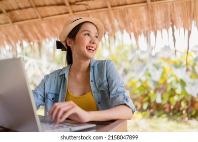 asian female freelance digital nomad millennial gen y  lifestyle relax casual working with laptop outdoor at balcony near the beach,asian female working anywhere new lifestyle working while travel