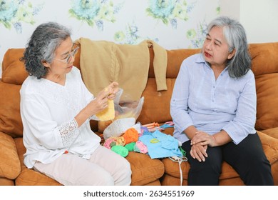 Asian female friends knitting on sofa at home, Senior women knitting together in living room
 - Powered by Shutterstock - Get 15% off with code: PIKWIZARD15