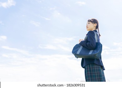 Asian Female High School Student Looking Up To Sky.