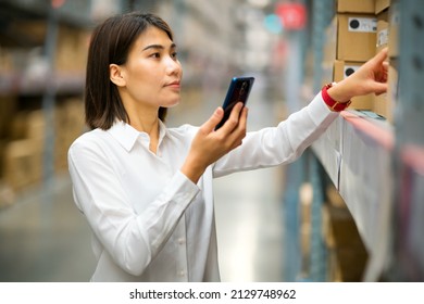 Asian Female Is Holding Mobile Phone And Checking Carton Of Product In Furniture Store