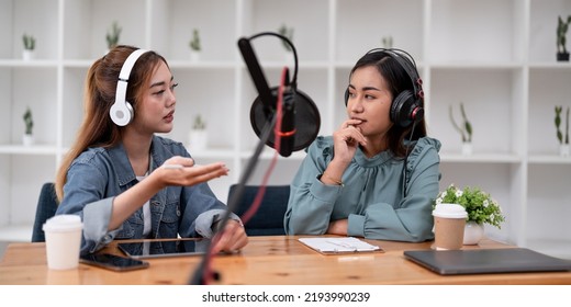 Asian Female Host Recording Radio Podcast Interview With Guest At Home Office