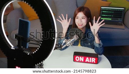 asian female internet celebrity have live stream with on air light sign and mobile phone at home