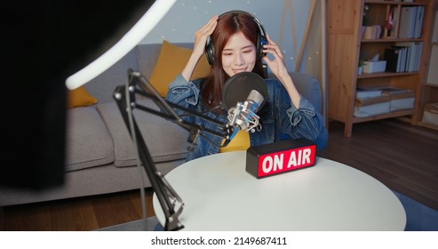 asian female internet celebrity is readying to record podcast at studio in the evening at home - Shutterstock ID 2149687411
