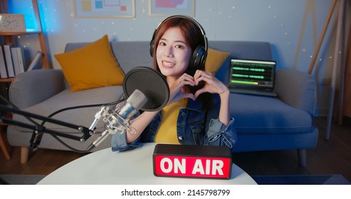 Asian Female Internet Celebrity Showing Heart Gesture Have Live Stream And Singing With On Air Light Sign At Home