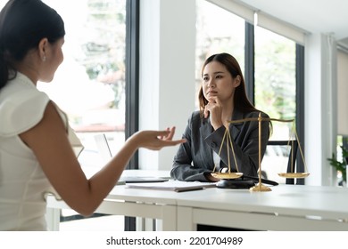 Asian Female Lawyer Discussing Negotiation Legal Case With Client Meeting With Document Contact In Courtroom, Law And Justice Concept