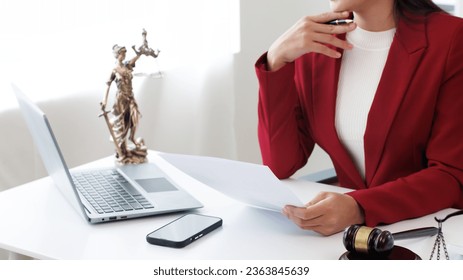 Asian female lawyer working in office or court with gavel and judge on table online legal advice - Powered by Shutterstock