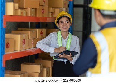 Asian Female And Male Warehouse Worker Working At The Storehouse. Logistics , Supply Chain And Warehouse Business Concept.