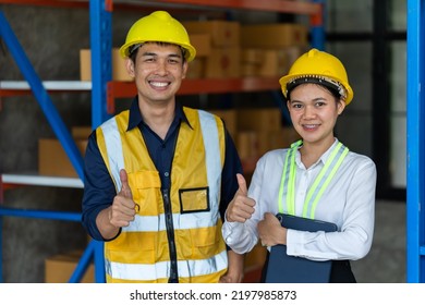 Asian Female And Male Warehouse Worker Working At The Storehouse. Logistics , Supply Chain And Warehouse Business Concept.