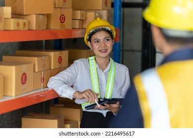 Asian Female And Male Warehouse Worker Working At The Storehouse. Logistics , Supply Chain And Warehouse Business Concept.