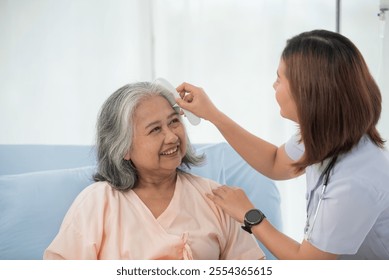 Asian female nurse combing hair of senior woman at the hospital ward, elderly care concept - Powered by Shutterstock