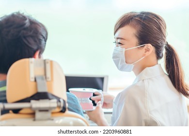 Asian Female Nurse And Patient (dentist)