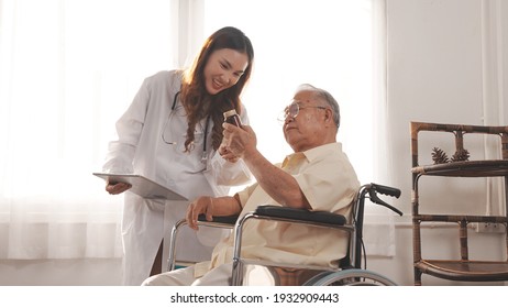 Asian Female Nurse Tells How To Take Medicine To Elderly Senior Grandfather Patient At Home Medical Visit, Elderly Old Male People Healthcare Support And Encouraging The Patient.