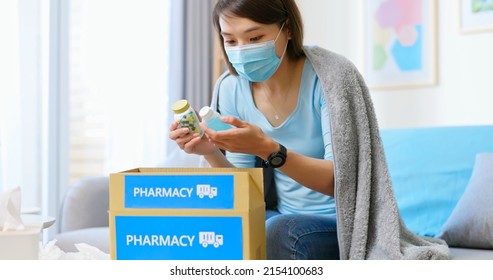 Asian Female Patient Wear Mask Covering Blanket Unpacked Medicine From Pharmacy Medication Package Box Delivery Service At Home